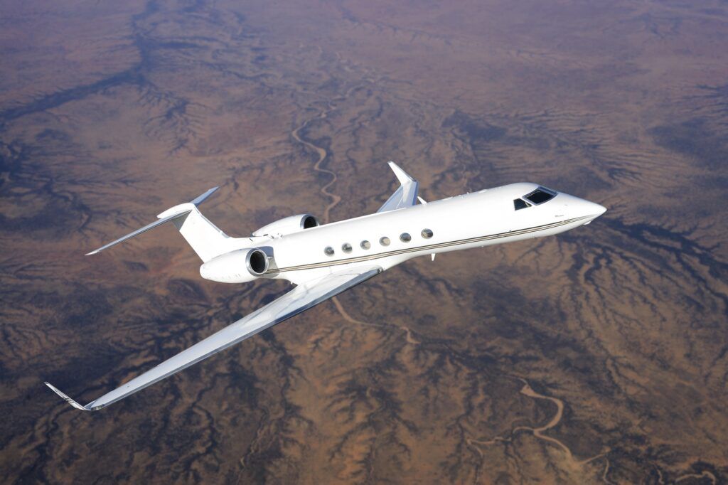 Private jet flying over desert