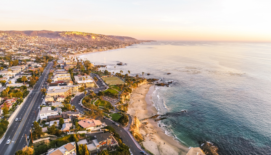 Aerial view of coastal town at sunset.