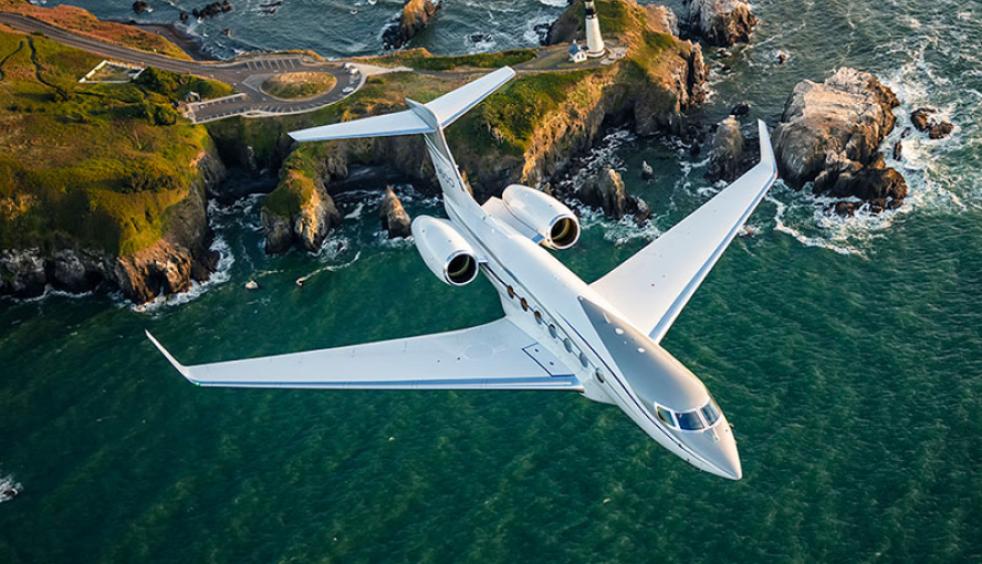 Private jet flying over coastline