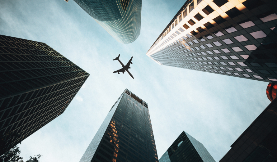 Plane flying over skyscrapers.